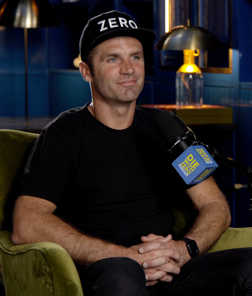 Austin Allison, host of Die With Zero, in the studio in his ZERO cap